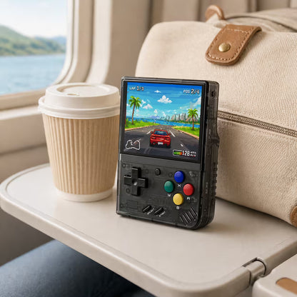 iGameConsole MIYOO Mini Plus transparent black portable gaming console on a travel tray table with a coffee cup and travel bag, showing retro gaming on the go.