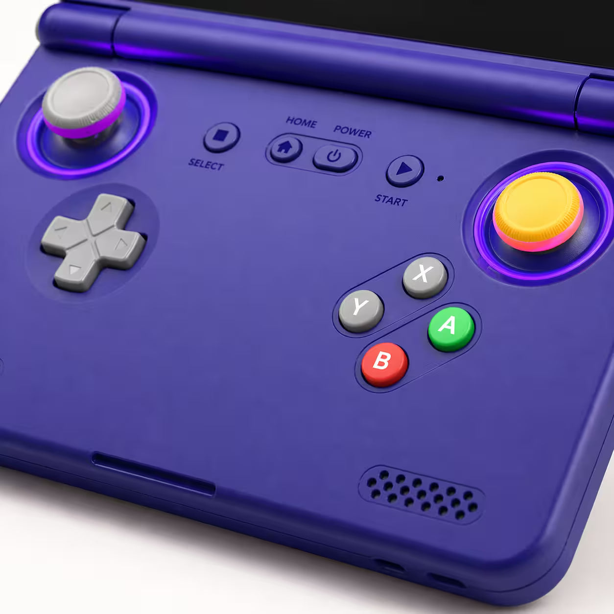 Close-up of the iGameConsole purple retro handheld console showing the glowing joysticks, silver D-pad, ABXY buttons, center controls, speaker grille, and matte shell finish.