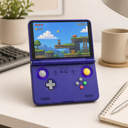 iGameConsole purple retro portable gaming console on a clean modern desk setup with a keyboard, coffee mug, notebook, plant, and colorful pixel game screen.