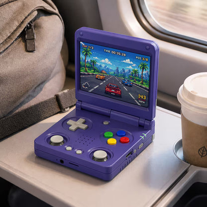 iGameConsole RG34XXSP Foldable Pro purple portable gaming console on a travel tray table with a coffee cup and travel bag, showing retro gaming on the go.