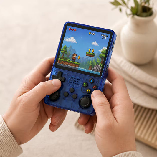 Adult hands holding the iGameConsole transparent blue portable handheld console, showing its compact size, comfortable grip, D-pad, dual joysticks, and colorful retro platform game screen.