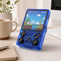 iGameConsole transparent blue retro portable console on a clean modern desk setup with a coffee mug, keyboard, notebook, and colorful pixel game screen.