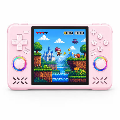 iGameConsole XF40H WiFi Pro pink retro handheld console shown as a standalone color option with a wide display, dual RGB-ring joysticks, D-pad, ABXY buttons, speaker vents, and colorful pixel adventure game screen on a clean white background.