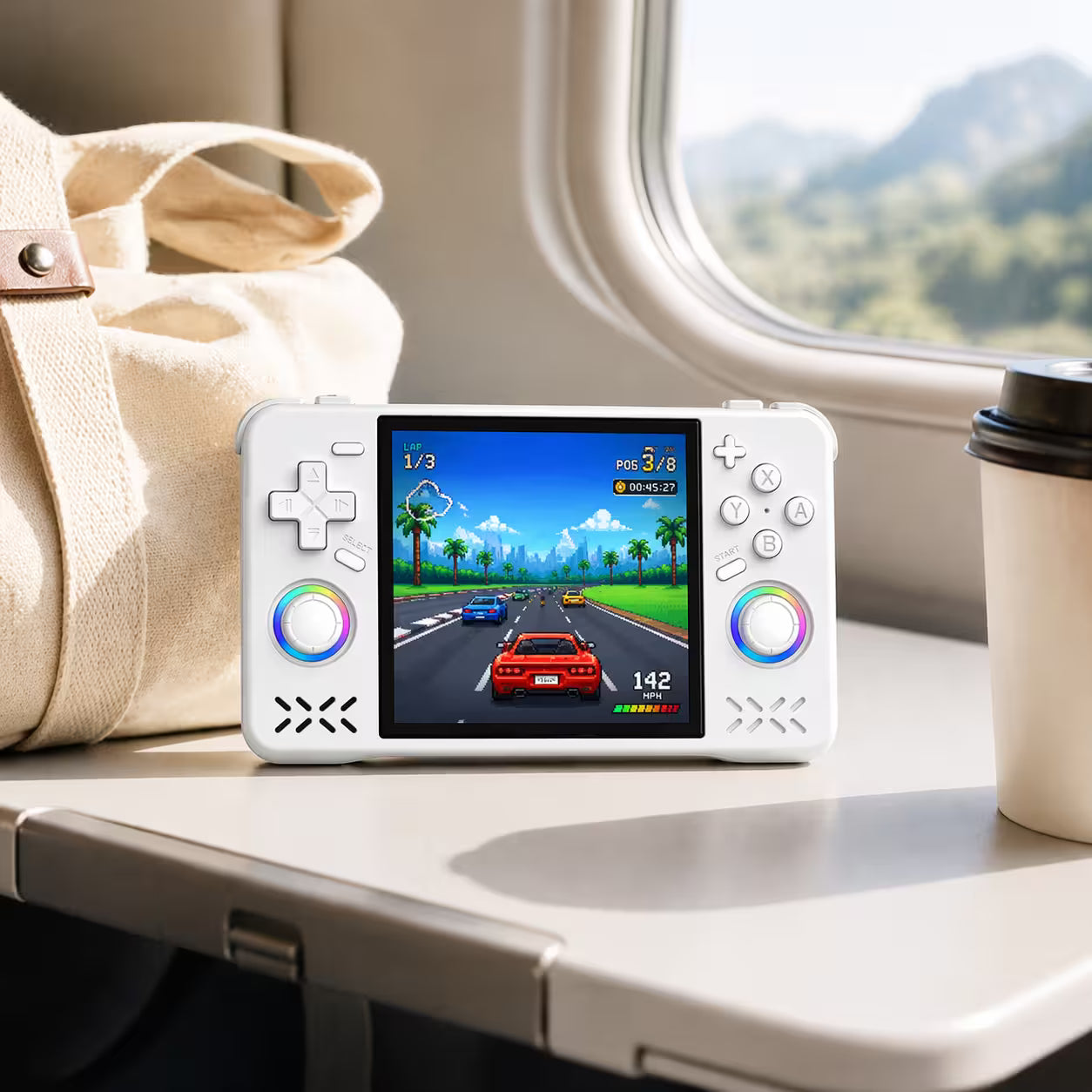 iGameConsole XF40H WiFi Pro white portable gaming console on a travel tray table with a coffee cup and travel bag, showing retro gaming on the go.