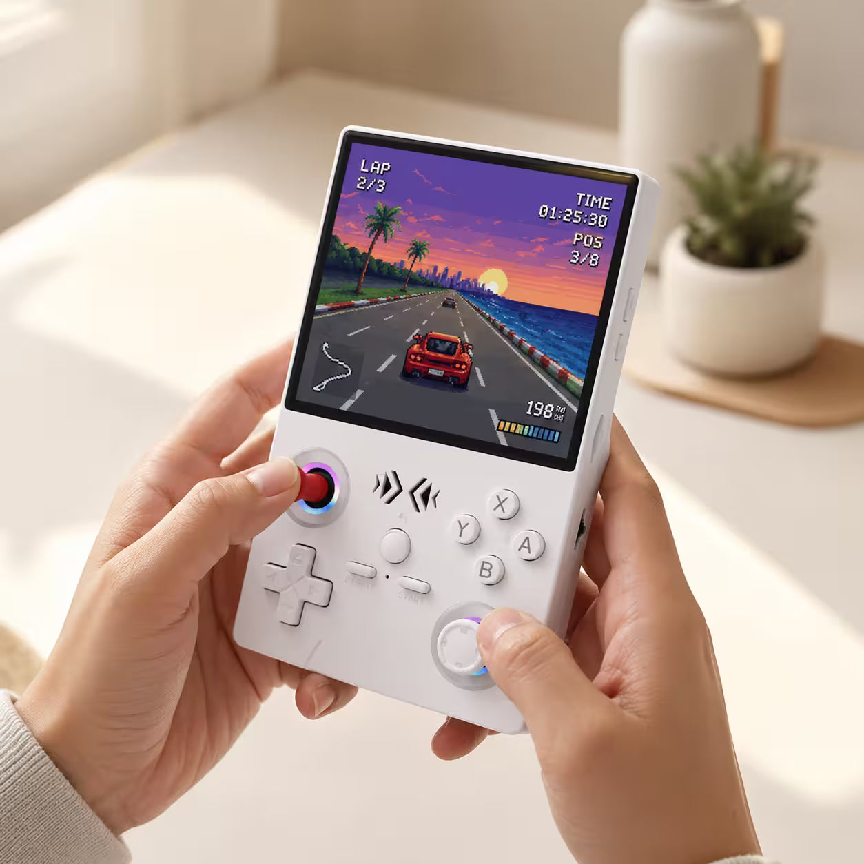 iGameConsole XF40V white portable handheld console held in adult hands, showing the red joystick, white controls, RGB ring accents, and retro racing game screen.